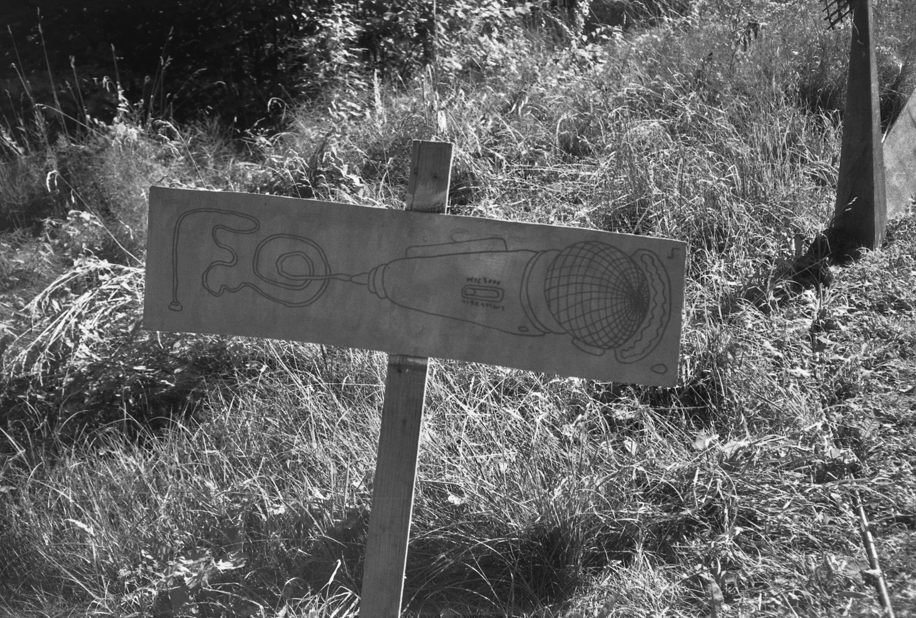Hand-drawn recording station sign in the grass