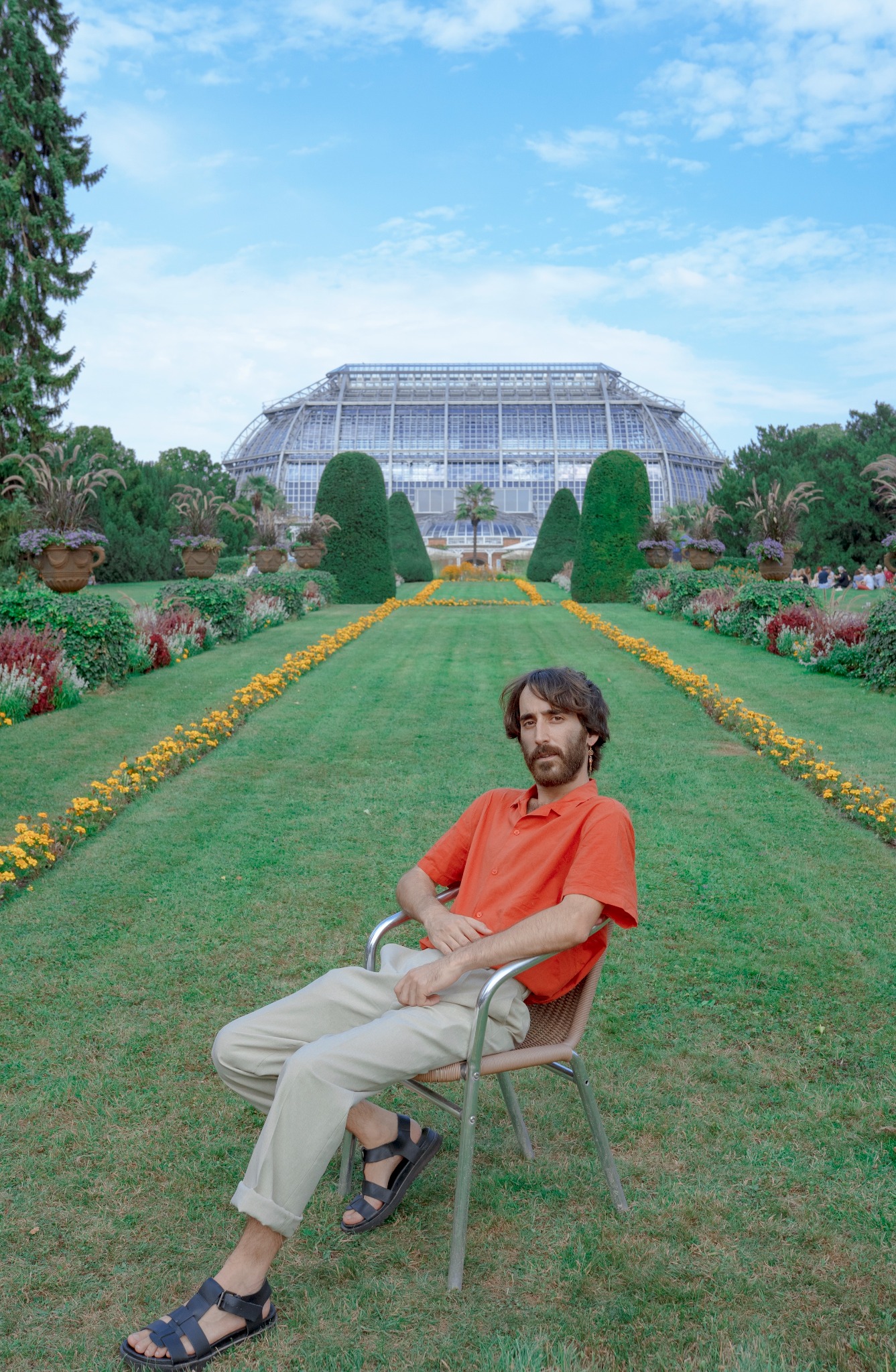 Liad Shulrufer sitting on a chair in a long garden
