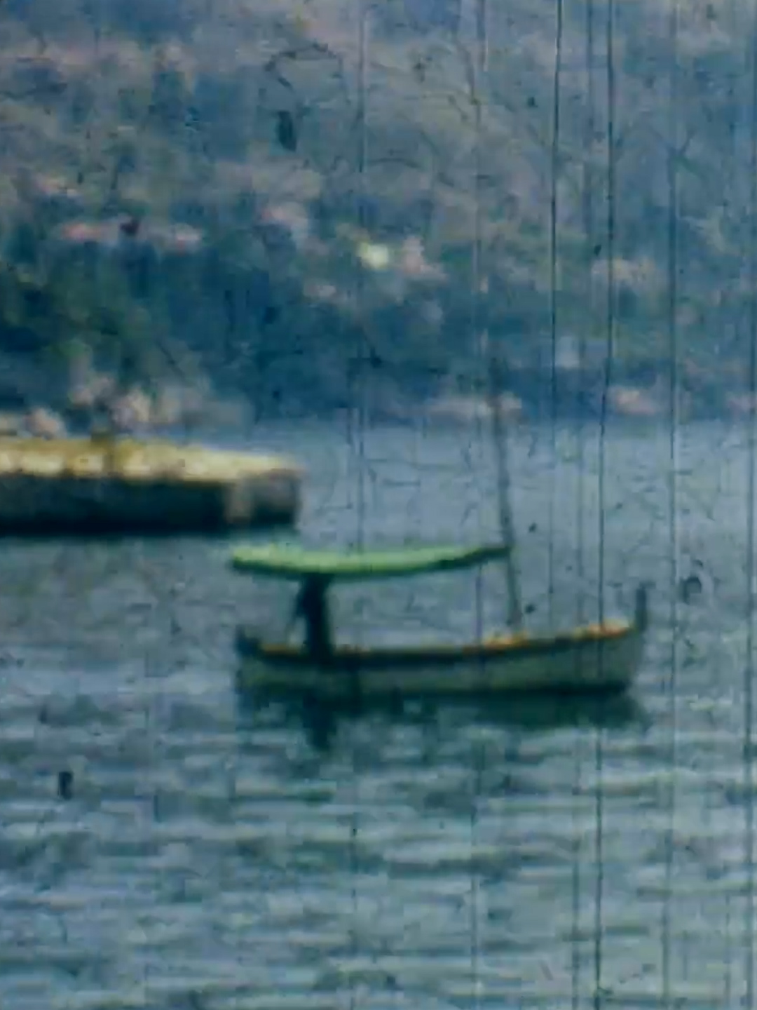 Boat on the water in an archival film frame
