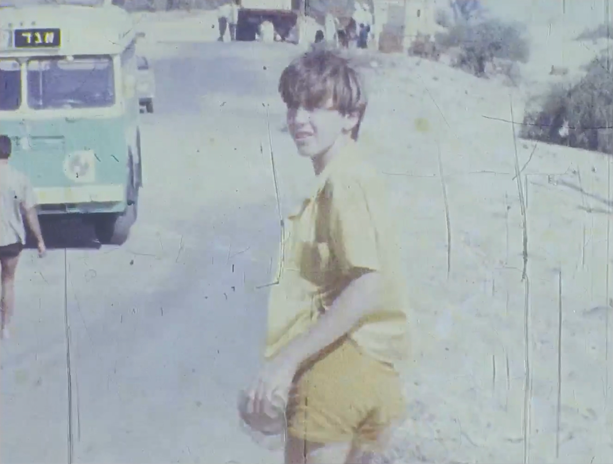 A child looking back toward the camera in an archival film frame